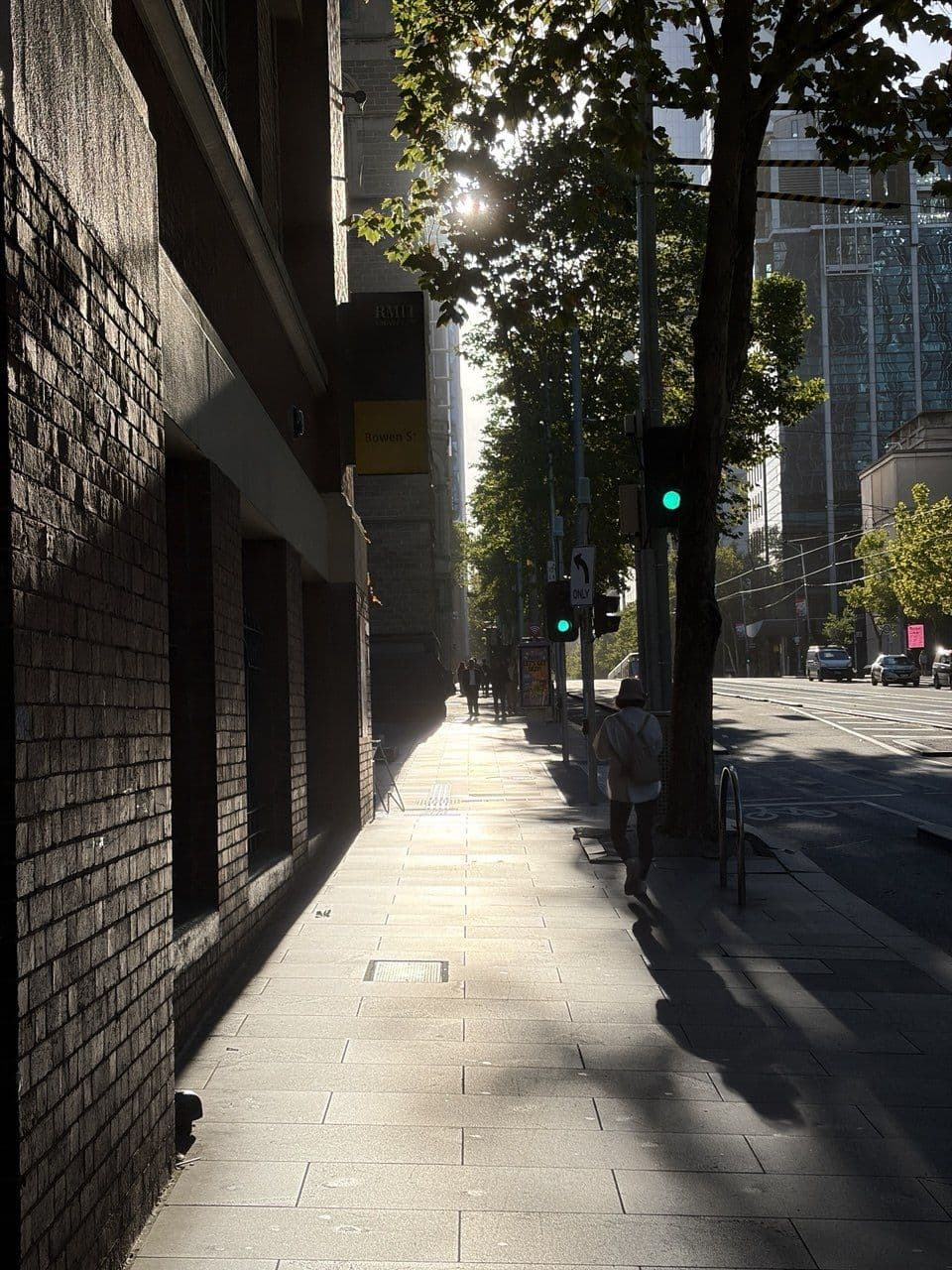 Backlit Melbourne CBD sidewalk with leading lines shot by Dam on a Fujifilm X-T5 during a photography course