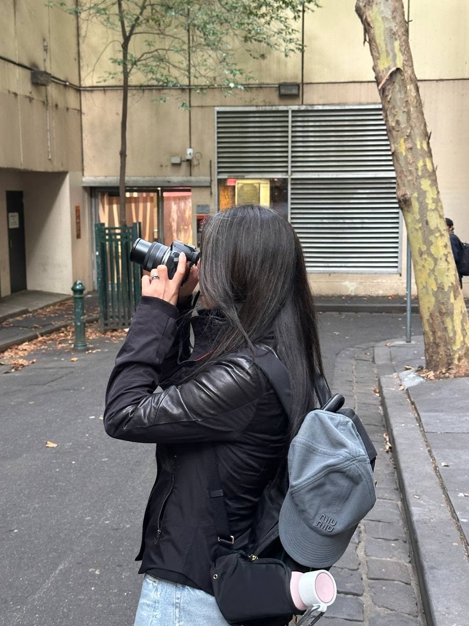 Janet shooting with her Canon R100 in a Melbourne CBD street during a photography course