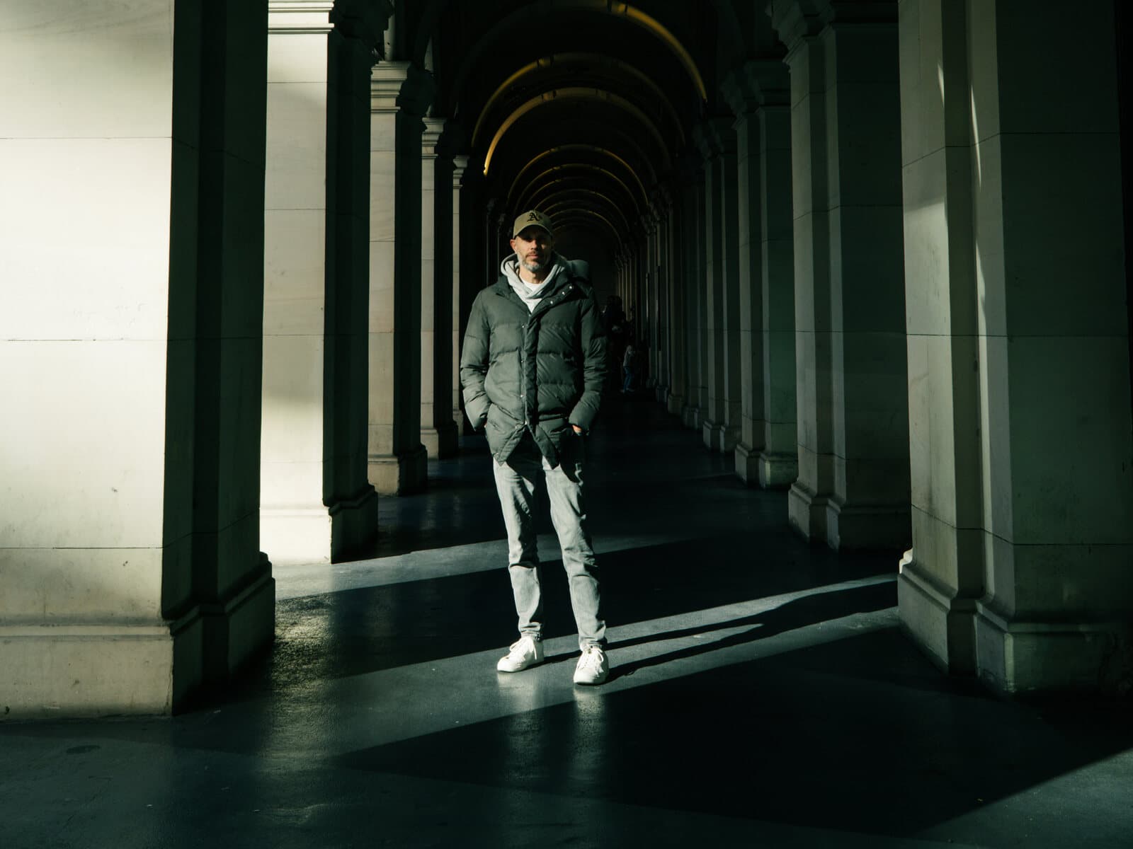 Daniel Bilsborough, founder and instructor of DJB Photography School, in a light-filled Melbourne CBD colonnade